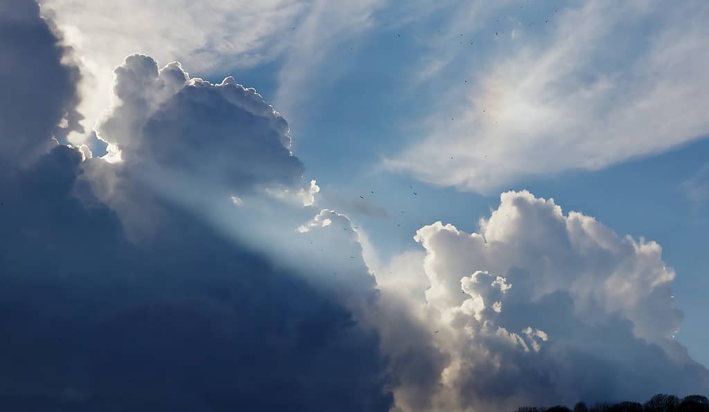 cumulunimbus clouds with sun rays